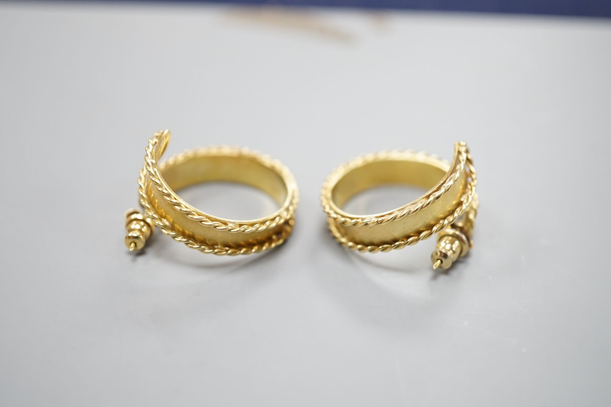 A pair of modern 18ct gold hoop earrings, with decorated borders, 27mm